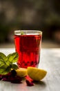 Popular Indian/Asian sharbat i.e GULAB KA SHARBAT with sliced lemon,Citrus Ãâ limon,Rosa,rose petals and mint leaves on a silver